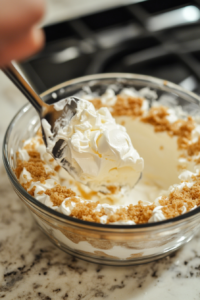 In a separate bowl, whip heavy cream until stiff peaks form